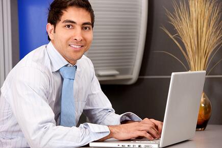 Business-man-in-an-office-with-a-laptop