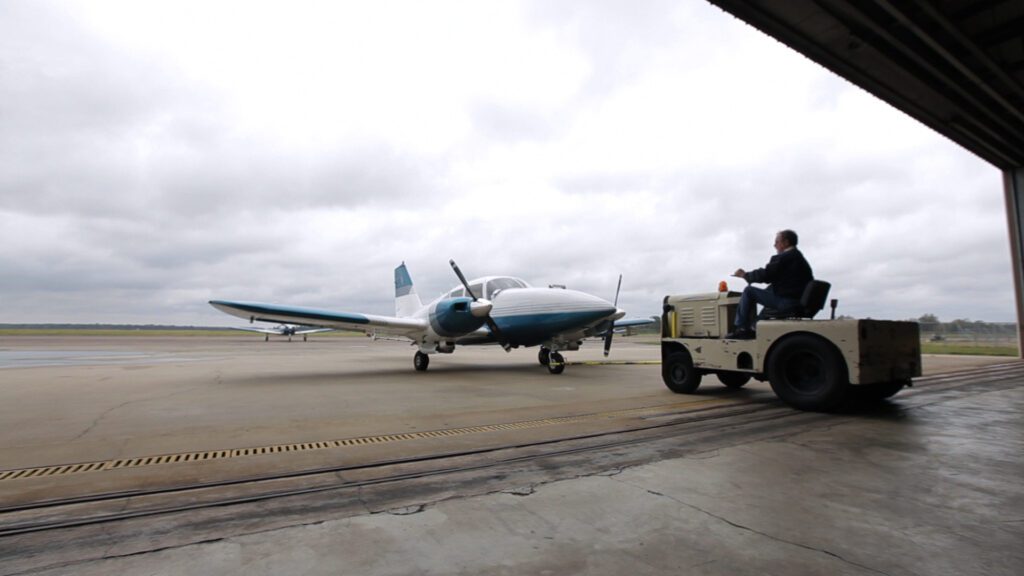 plane-on-tug-coming-out-of-hanger