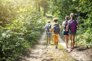 family-hiking-through-woods