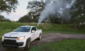 VDCI mosquito control truck performing fogging treatment outdoors