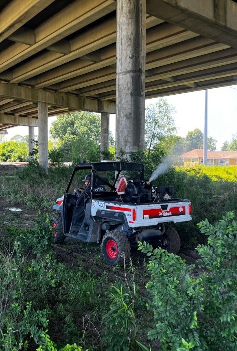 vdci mosquito expert performing adulticiding under bridge